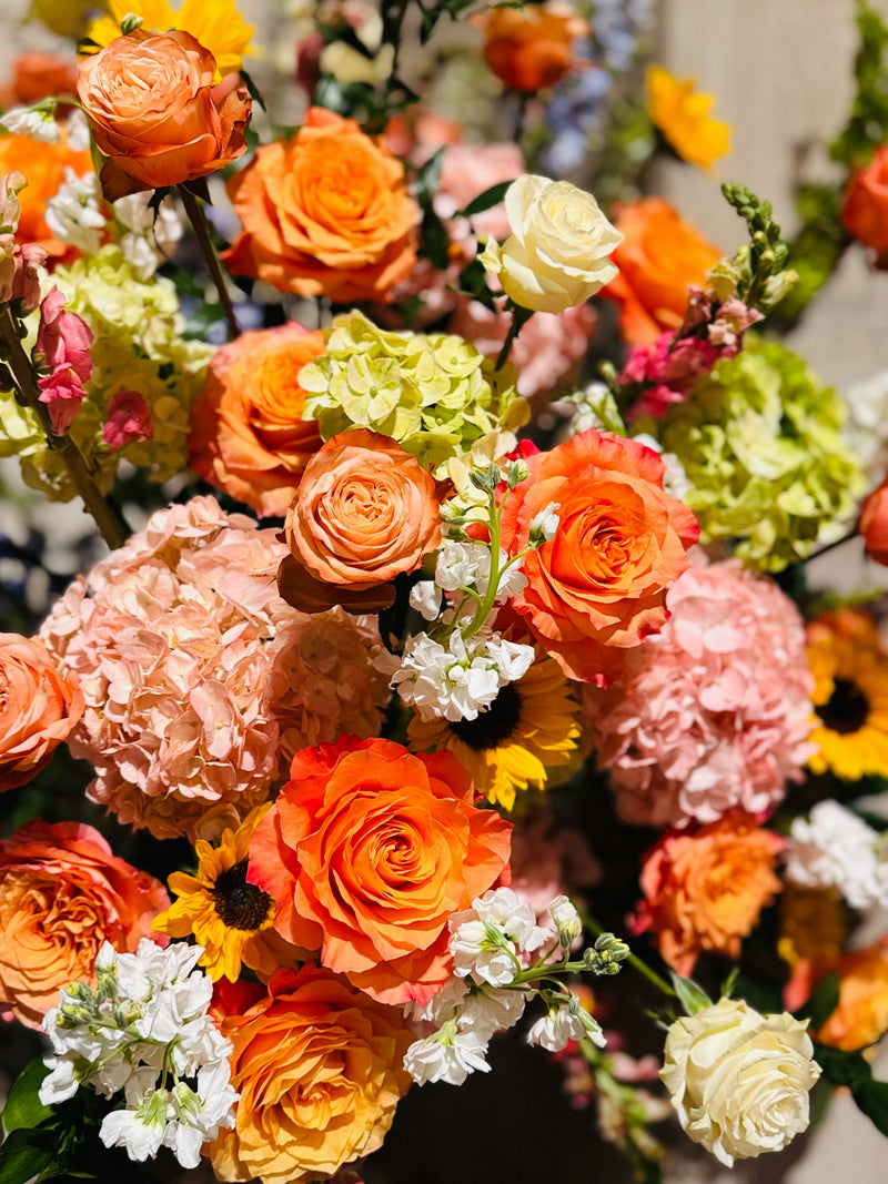 Orange roses with pink hydrangea and white stock